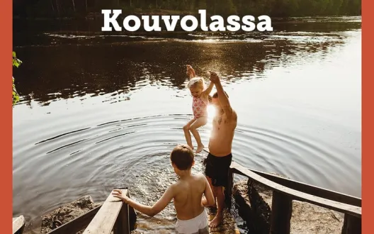 A man and two children stepping to water on sunny summer day. 