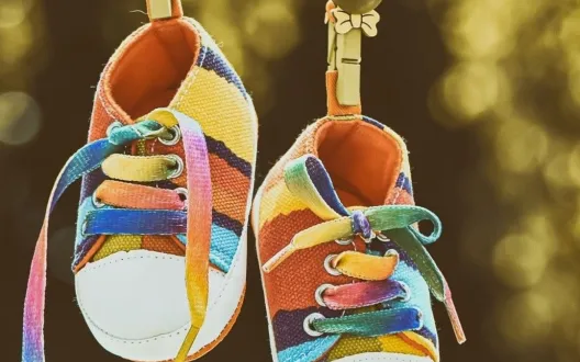 Kuva värikkäistä vauvan tossuista sekä teksti Touhutreffit ja Kittilän perhekeskuksen logo