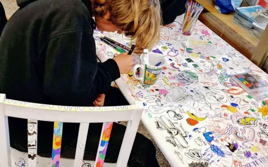 Students drawing to the table