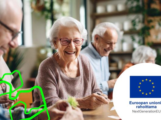 Ikäihmisiä istumassa pöydän ääressä keskustelemassa. Kaikki ovat iloisia.