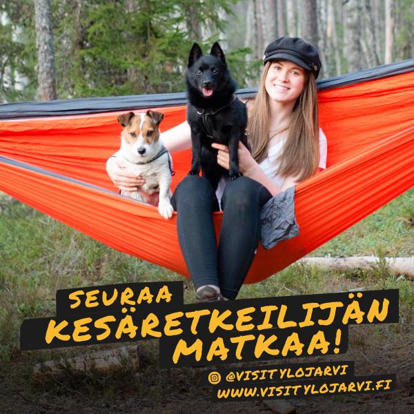 Mainoskuva, jossa nainen istuu riippumatossas kahden koiran kanssa.