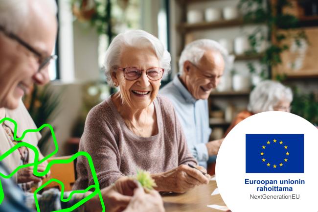 Ikäihmisiä istumassa pöydän ääressä keskustelemassa. Kaikki ovat iloisia.